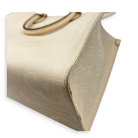 OnTheGo Tote Bag MM White in Empreinte Leather, Gold hardware
